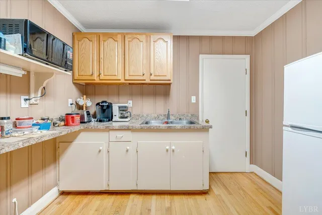 a kitchen with stainless steel appliances granite countertop a refrigerator and a stove