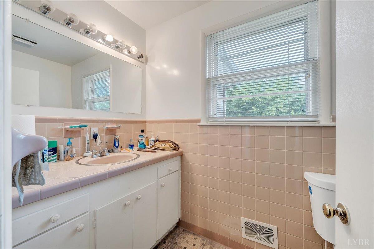 155 Laxton Road Lynchburg, VA 24502 - Photo 31 of 58 a bathroom with a double vanity sink a toilet and a mirror
