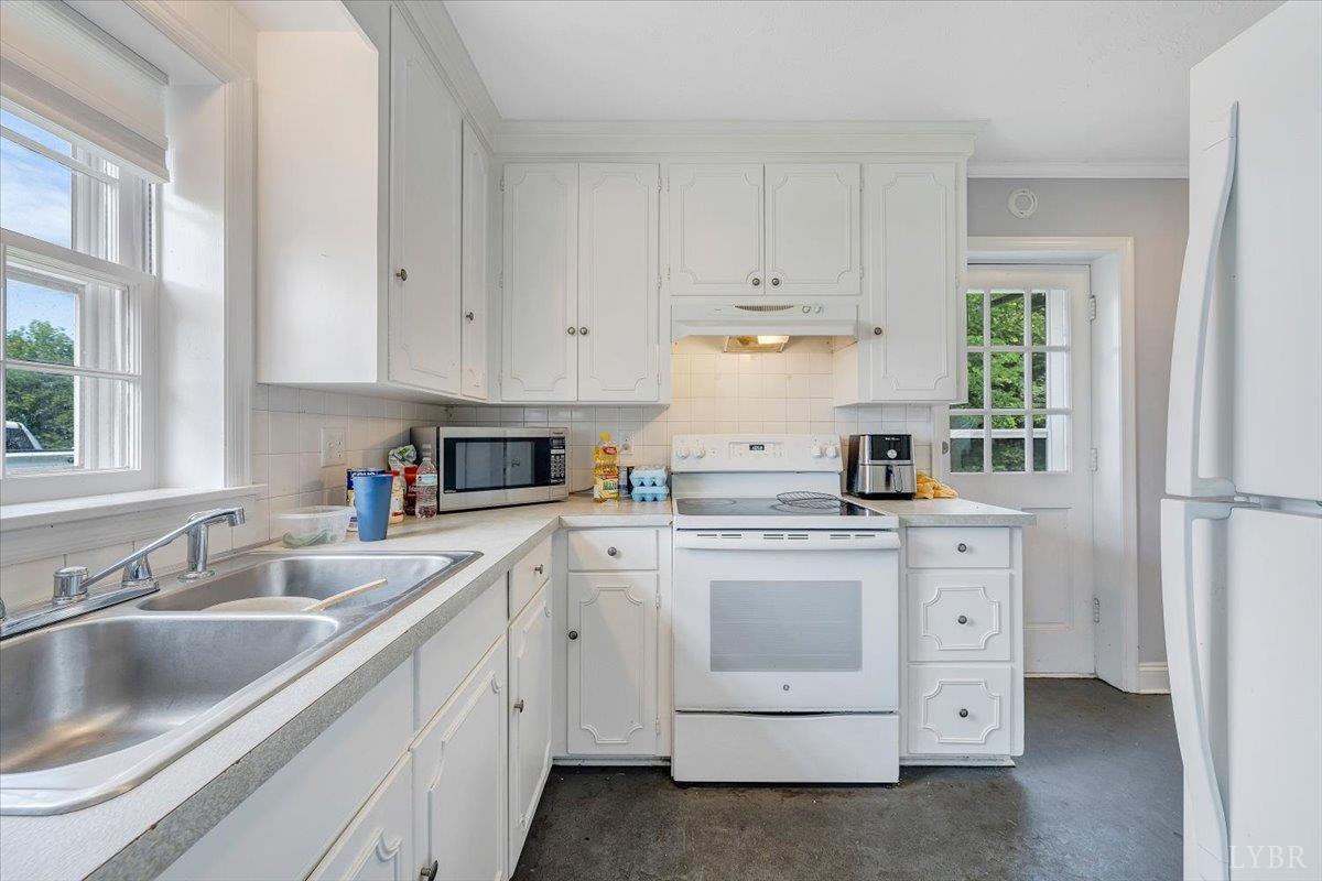 155 Laxton Road Lynchburg, VA 24502 - Photo 37 of 58 a kitchen with white cabinets appliances and a sink