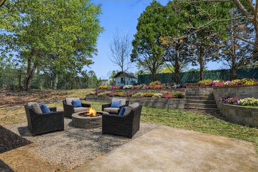2222 Barnes Drive Columbus, GA 31907 - Photo 17 of 49 a view of a patio with couches and a fire pit and a yard