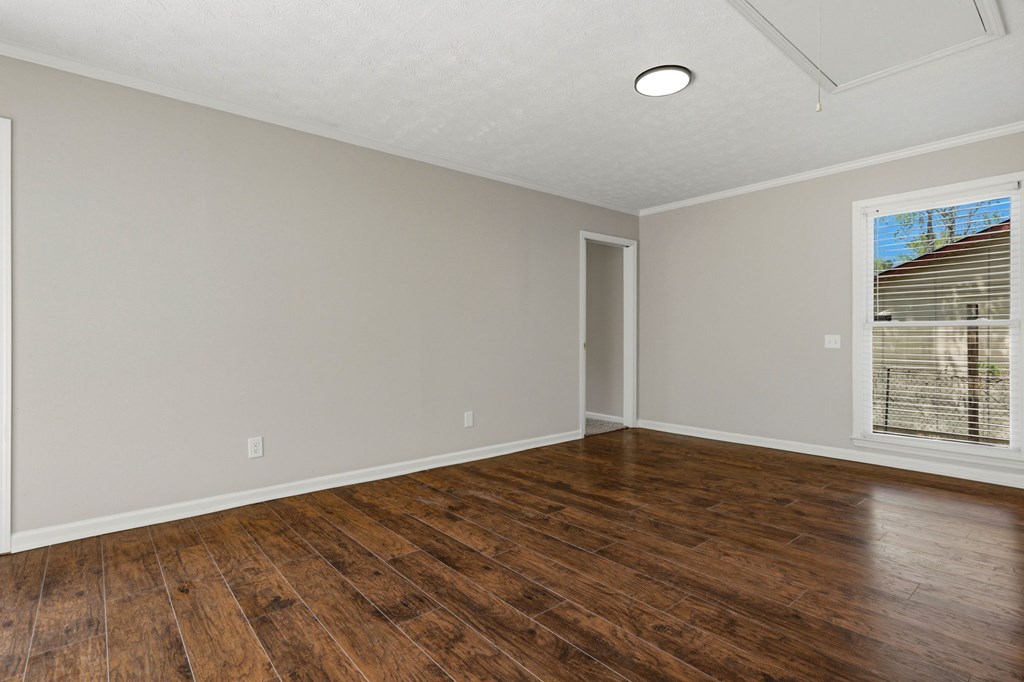 2222 Barnes Drive Columbus, GA 31907 - Photo 29 of 49 a view of an empty room with wooden floor and a window