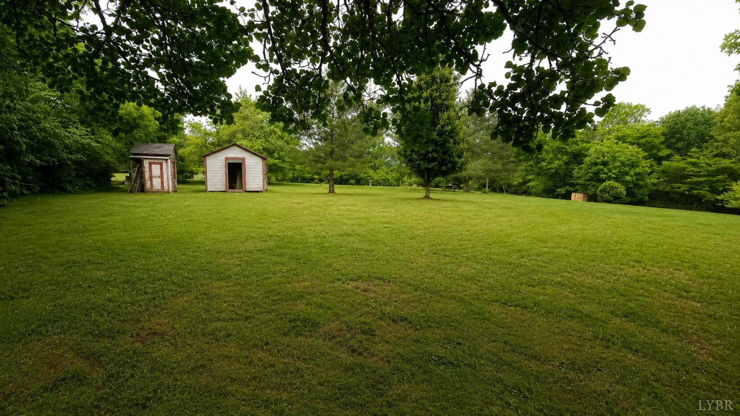 2346 Mitchell Mill Road Gladys, VA 24554 - Photo 37 of 38 a view of a big yard with a house and large trees