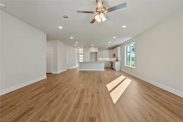 a view of kitchen and hall with wooden floor