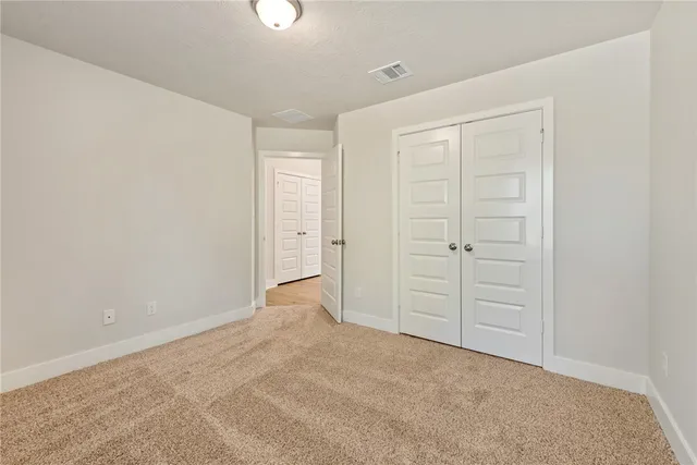 an empty room with closet area