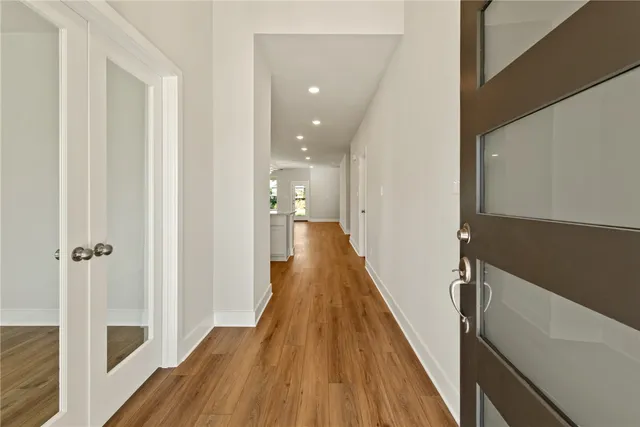 a view of a hallway with wooden floor and staircase