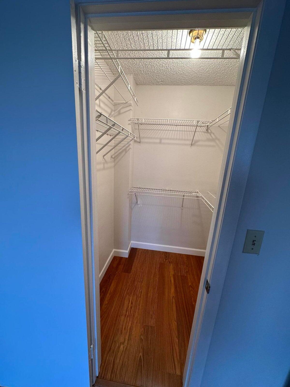 9355 Southwest 8th Street, Unit 421 Boca Raton, FL 33428 - Photo 13 of 20 a view of walk in closet with wooden floor