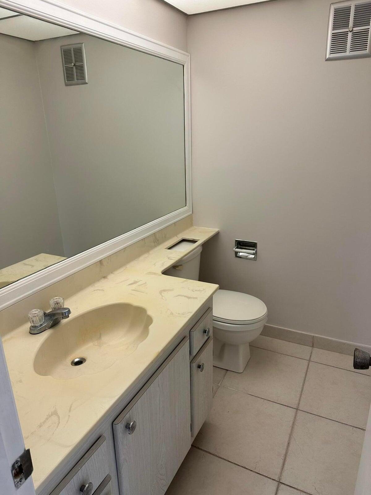 9355 Southwest 8th Street, Unit 421 Boca Raton, FL 33428 - Photo 9 of 20 a bathroom with a sink and a toilet