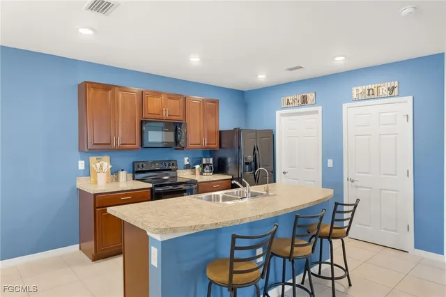 a kitchen with a table chairs refrigerator and cabinets