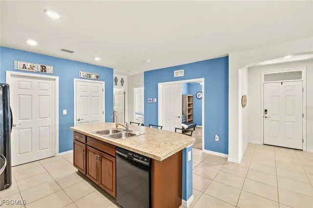 a kitchen with a stove a sink and a refrigerator