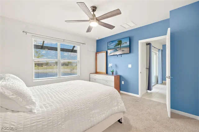 a bedroom with a large bed and a large window