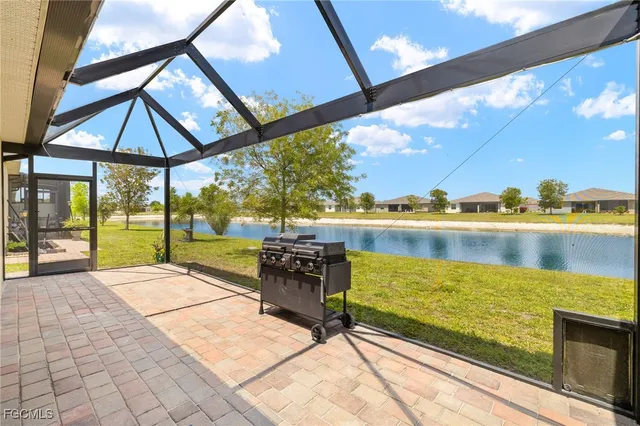 a view of a lake with couches and wooden floor