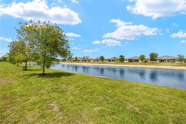 a view of a lake with houses in the background