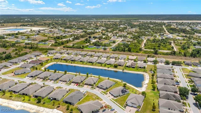 a view of a swimming pool with a yard and lake view