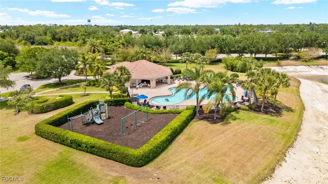 a view of a swimming pool with a garden and trees