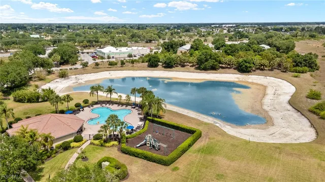 a view of a house with swimming pool and sitting area
