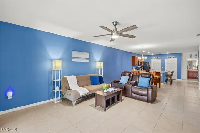 a living room with furniture and a ceiling fan