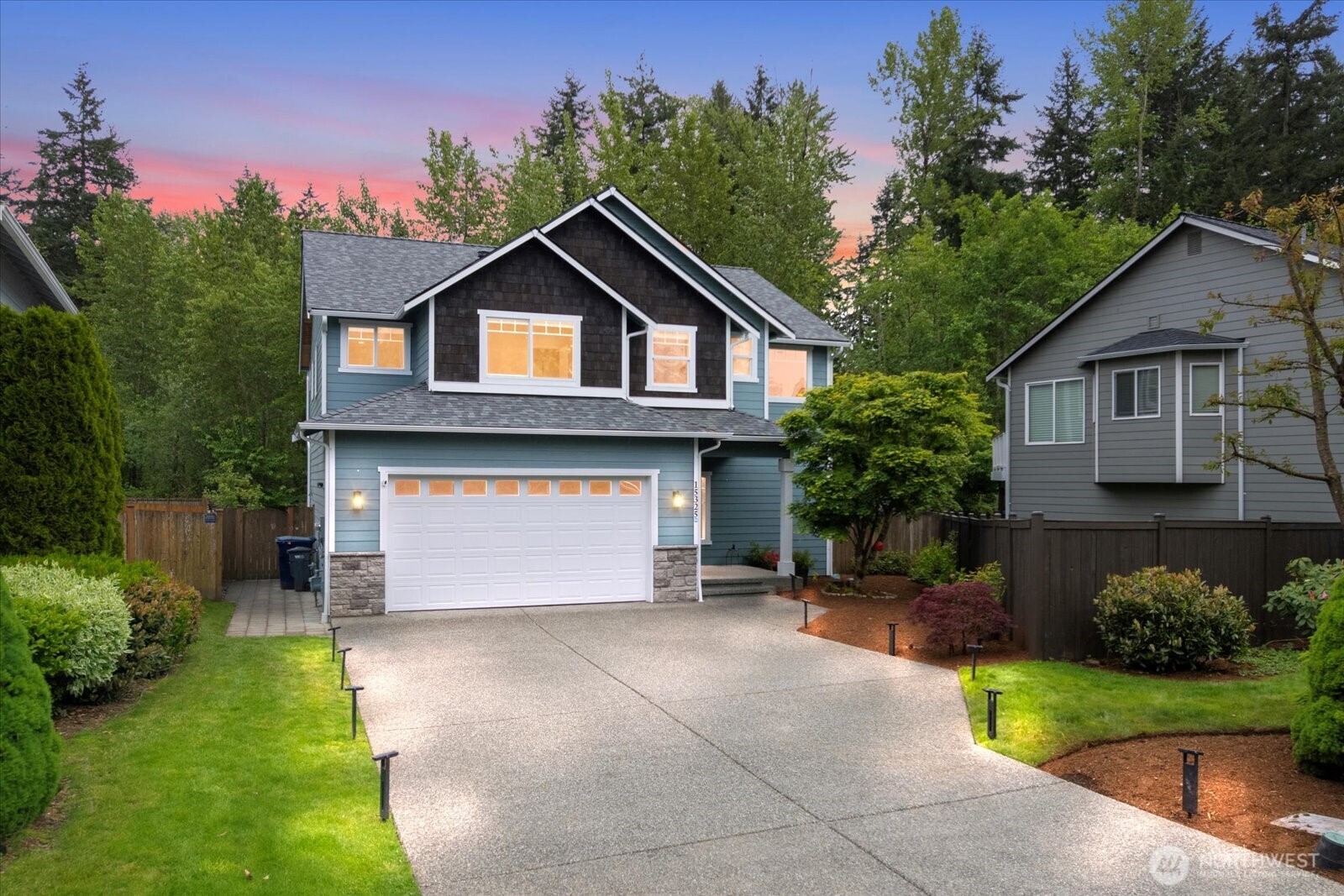 a front view of a house with a yard and garage