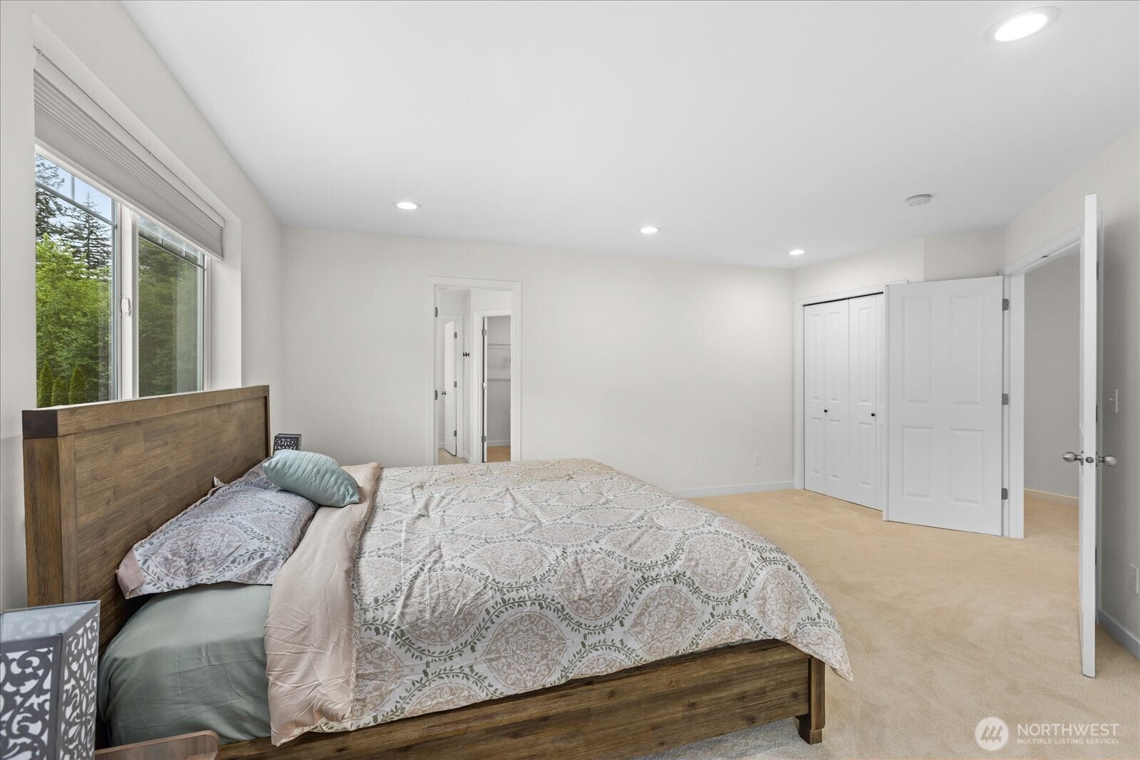 15325 Sunset Road Bothell, WA 98012 - Photo 17 of 40 a spacious bedroom with a bed and a large window