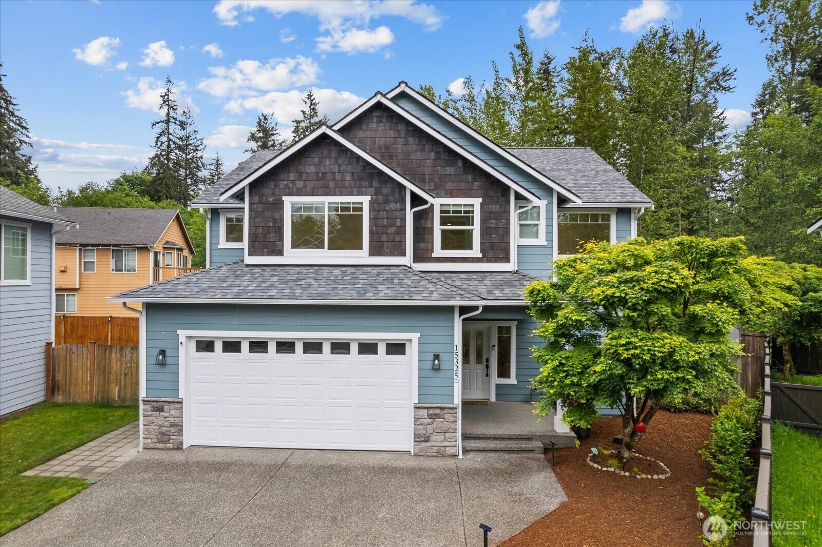 15325 Sunset Road Bothell, WA 98012 - Photo 2 of 40 a front view of a house with a garage and garage