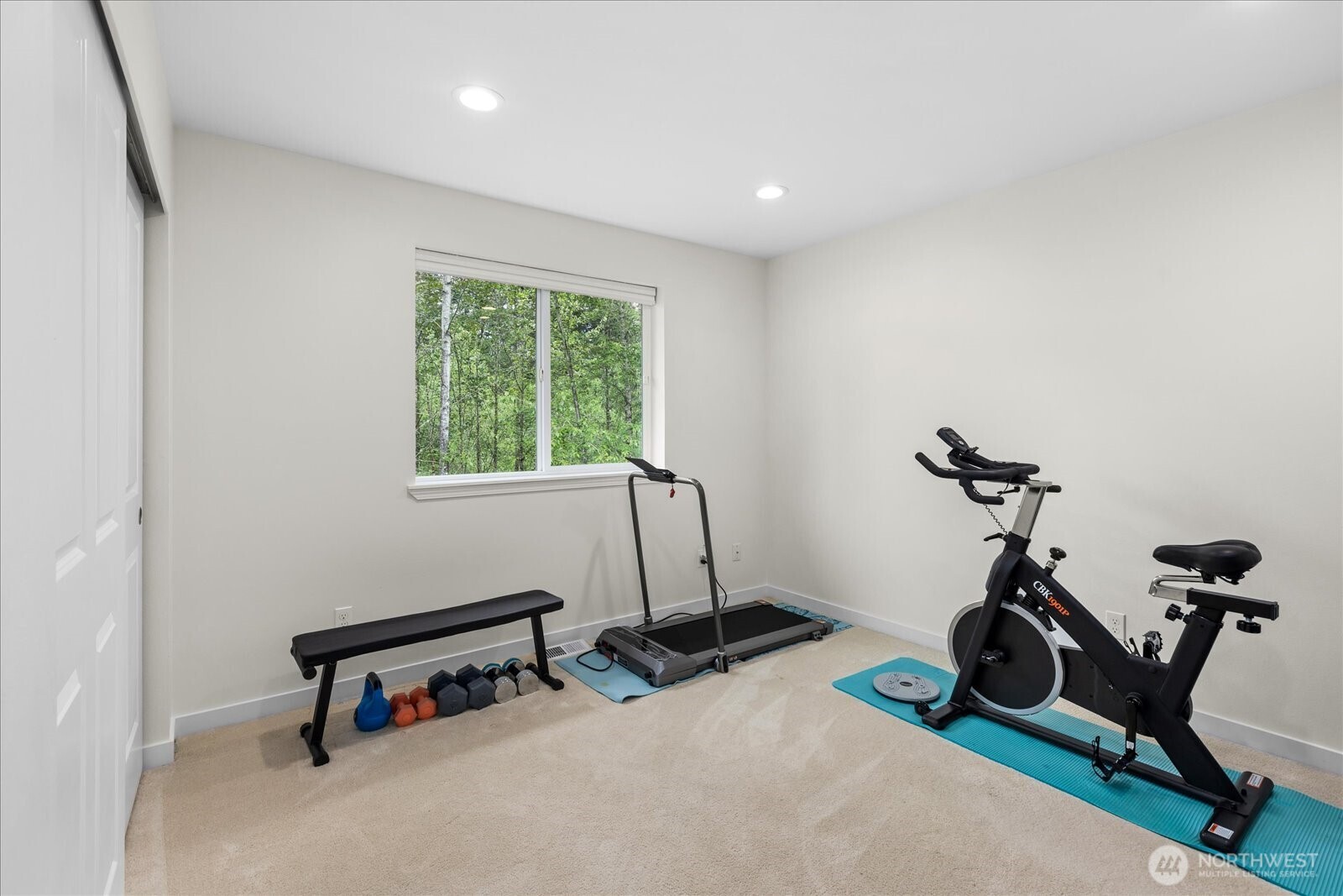15325 Sunset Road Bothell, WA 98012 - Photo 24 of 40 a room with gym equipment and a wooden floor