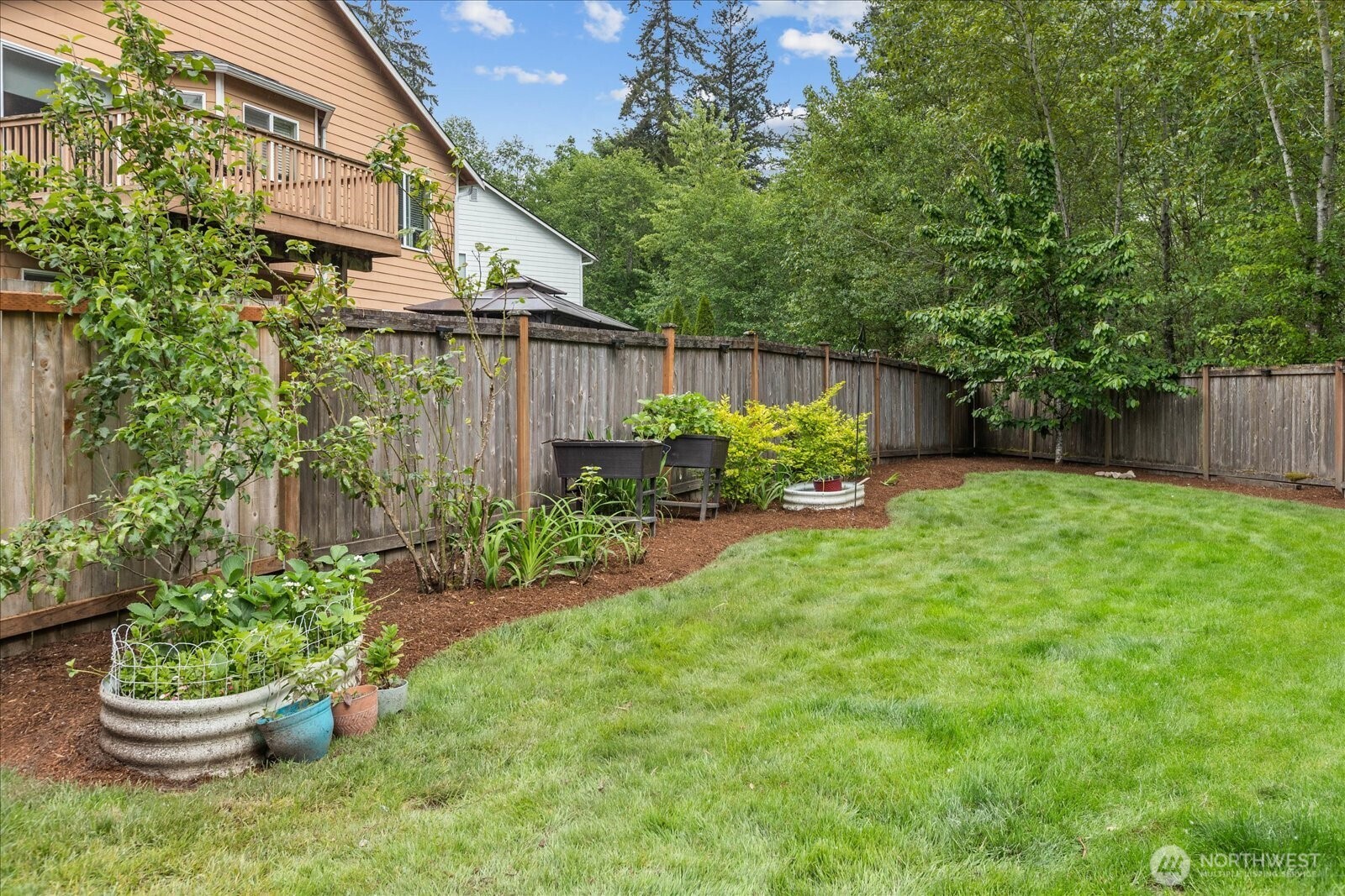 15325 Sunset Road Bothell, WA 98012 - Photo 33 of 40 a house with a yard and a garden