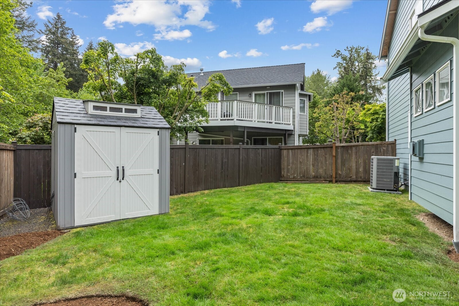 15325 Sunset Road Bothell, WA 98012 - Photo 35 of 40 a view of a backyard with plants and a fence