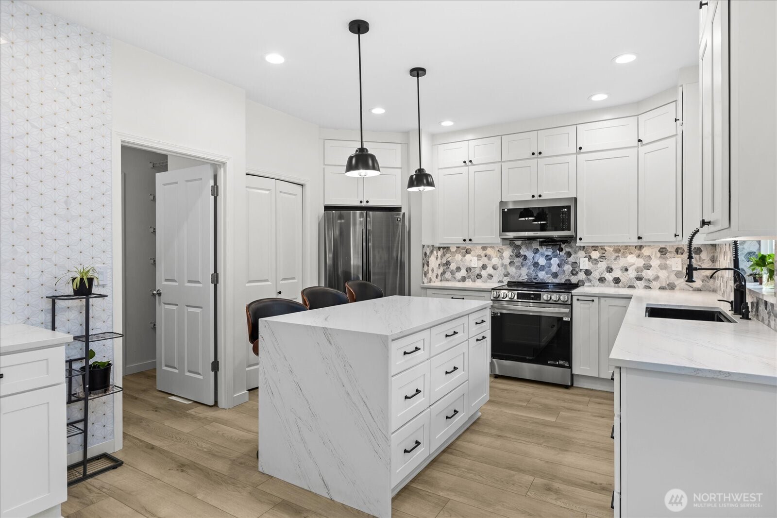 15325 Sunset Road Bothell, WA 98012 - Photo 5 of 40 a kitchen with stainless steel appliances kitchen island granite countertop a refrigerator a stove and a sink