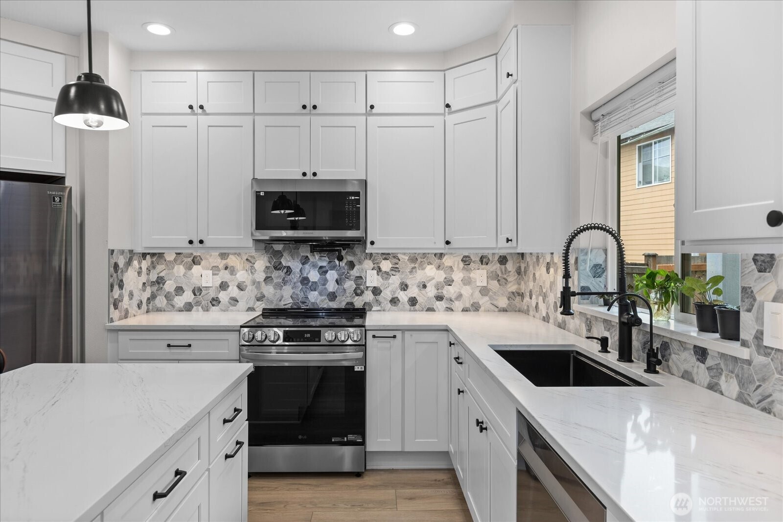 15325 Sunset Road Bothell, WA 98012 - Photo 6 of 40 a kitchen with a sink stove and refrigerator