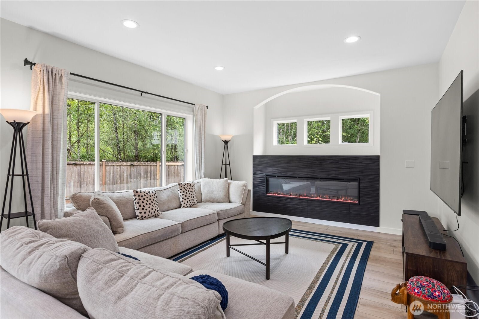 15325 Sunset Road Bothell, WA 98012 - Photo 10 of 40 a living room with furniture a flat screen tv and a fireplace
