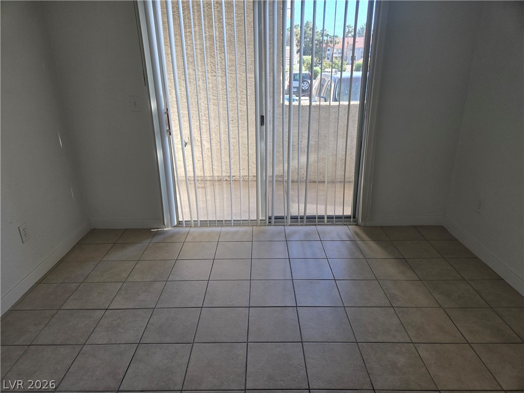 6250 West Flamingo Road, Unit 131 Las Vegas, NV 89103 - Photo 9 of 11 A sliding glass door provides access to a private patio, perfect for outdoor relaxation.