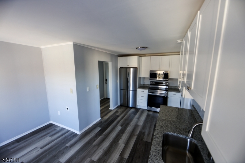 174 Main Street, Unit 2L Franklin, NJ 07416 - Photo 4 of 11 a kitchen with a refrigerator and a stove top oven