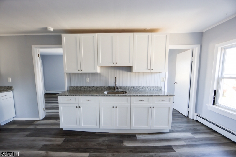 174 Main Street, Unit 2L Franklin, NJ 07416 - Photo 5 of 11 a kitchen with granite countertop white cabinets and a stainless steel appliances