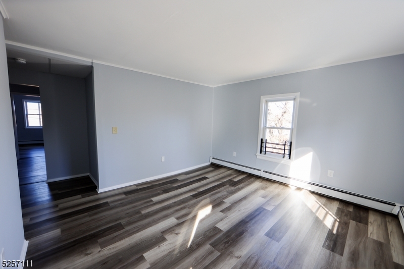 174 Main Street, Unit 2L Franklin, NJ 07416 - Photo 6 of 11 wooden floor in an empty room with a window