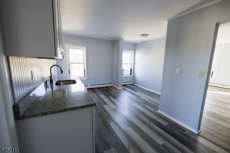 174 Main Street, Unit 2L Franklin, NJ 07416 - Photo 7 of 11 a kitchen with granite countertop a sink a stove and granite counter tops