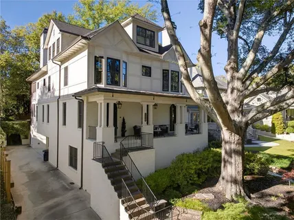 a front view of a house with yard and green space