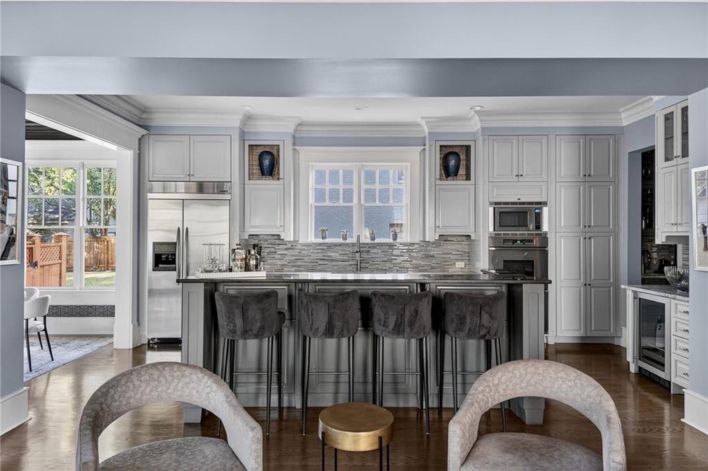 1326 Lanier Boulevard Northeast Atlanta, GA 30306 - Photo 29 of 84 a kitchen with a table chairs stove and refrigerator