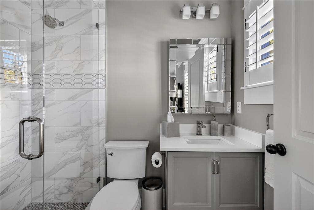1326 Lanier Boulevard Northeast Atlanta, GA 30306 - Photo 57 of 84 a bathroom with a granite countertop sink toilet and shower