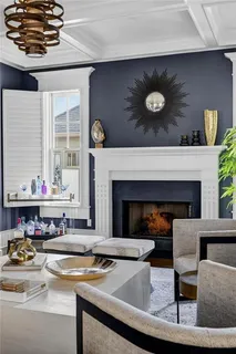 a kitchen with stainless steel appliances granite countertop a stove top oven a sink dishwasher a dining table and chairs with wooden floor