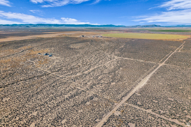 3825 West 5200th Road North Beryl, UT 84714 - Photo 3 of 10 Aerial view of sparsely populated area with a desert landscape and a mountainous background