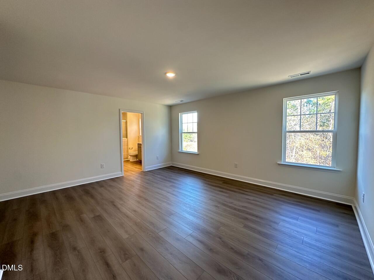 4961 Trout Crst Court Raleigh, NC 27604 - Photo 14 of 25 an empty room with wooden floor and window
