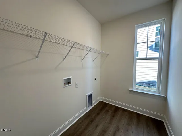 a view of a small space with wooden floor and windows