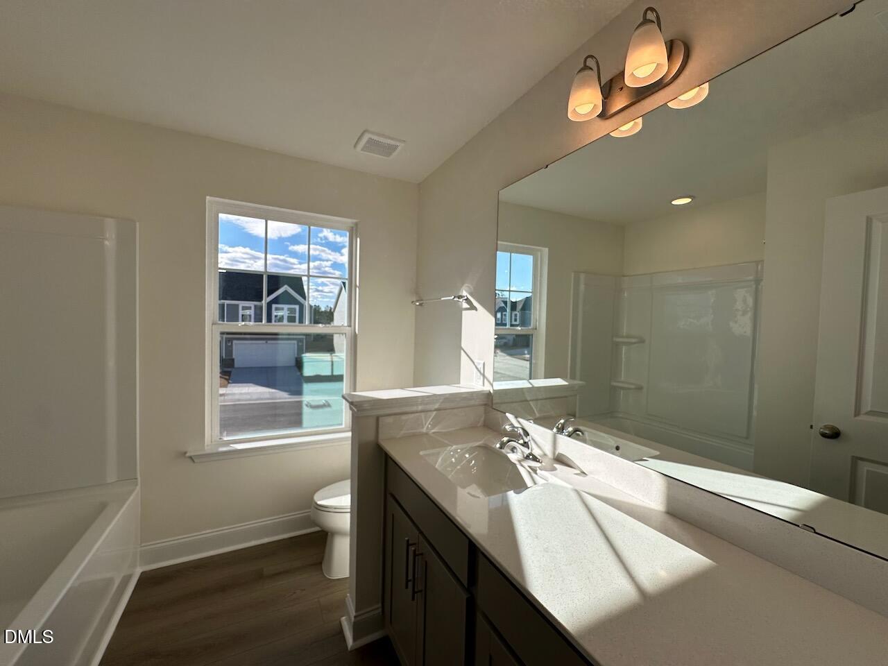 4961 Trout Crst Court Raleigh, NC 27604 - Photo 19 of 25 a bathroom with a sink a toilet and a shower