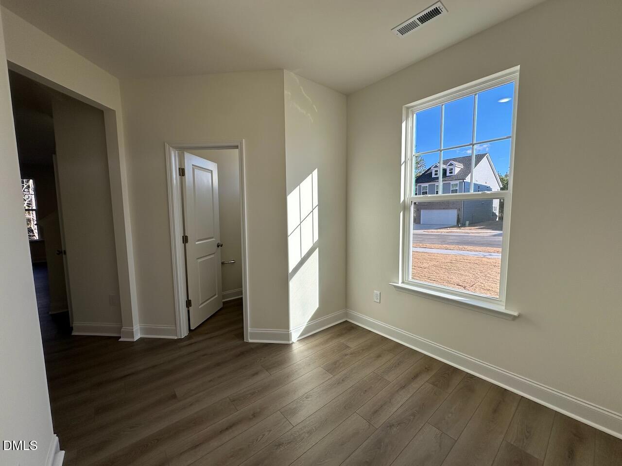 4961 Trout Crst Court Raleigh, NC 27604 - Photo 2 of 25 a view of an empty room with wooden floor and a window