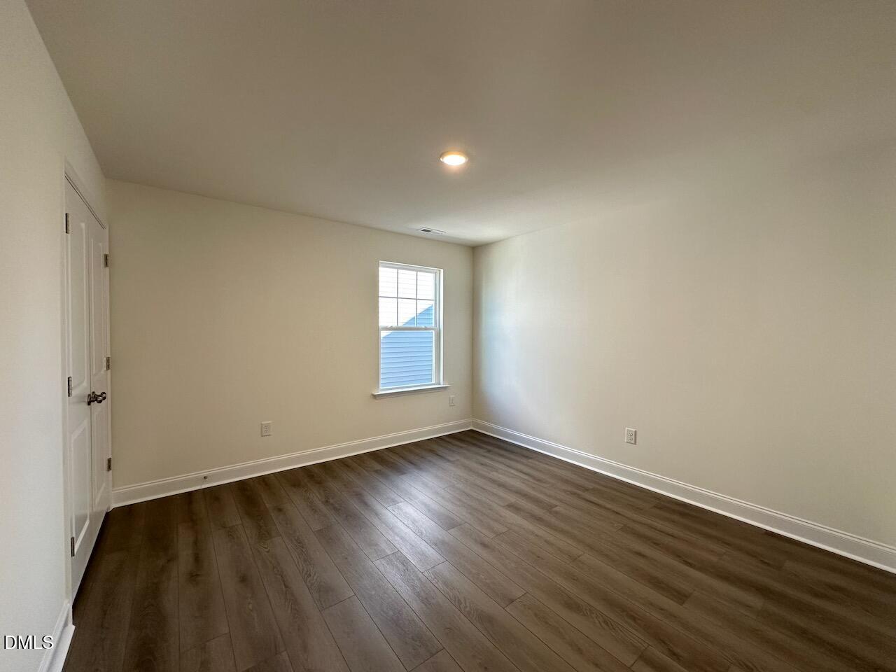 4961 Trout Crst Court Raleigh, NC 27604 - Photo 23 of 25 a view of an empty room with wooden floor and a window