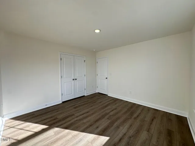 a view of an empty room and wooden floor