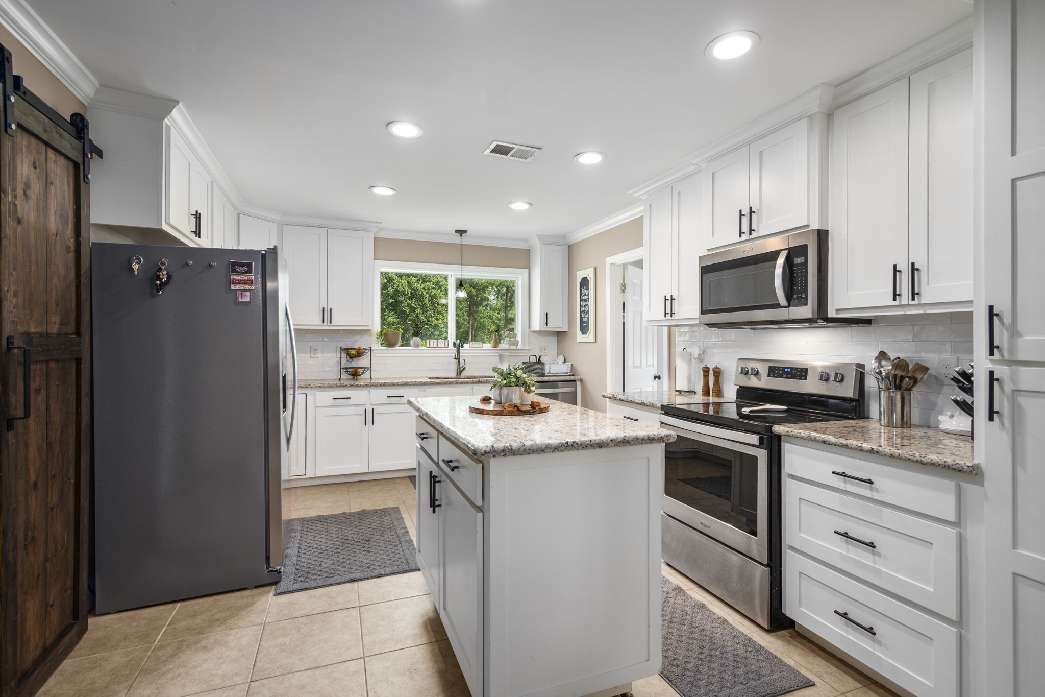 25311 Hardin Store Road Pinehurst, TX 77362 - Photo 10 of 39 a kitchen with a sink stove and refrigerator