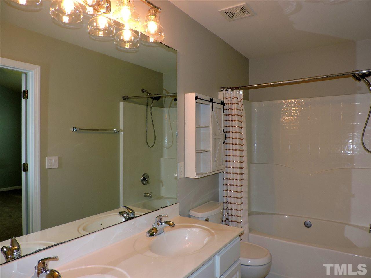 7242 Janston Drive Raleigh, NC 27613 - Photo 14 of 24 a bathroom with a sink toilet and shower