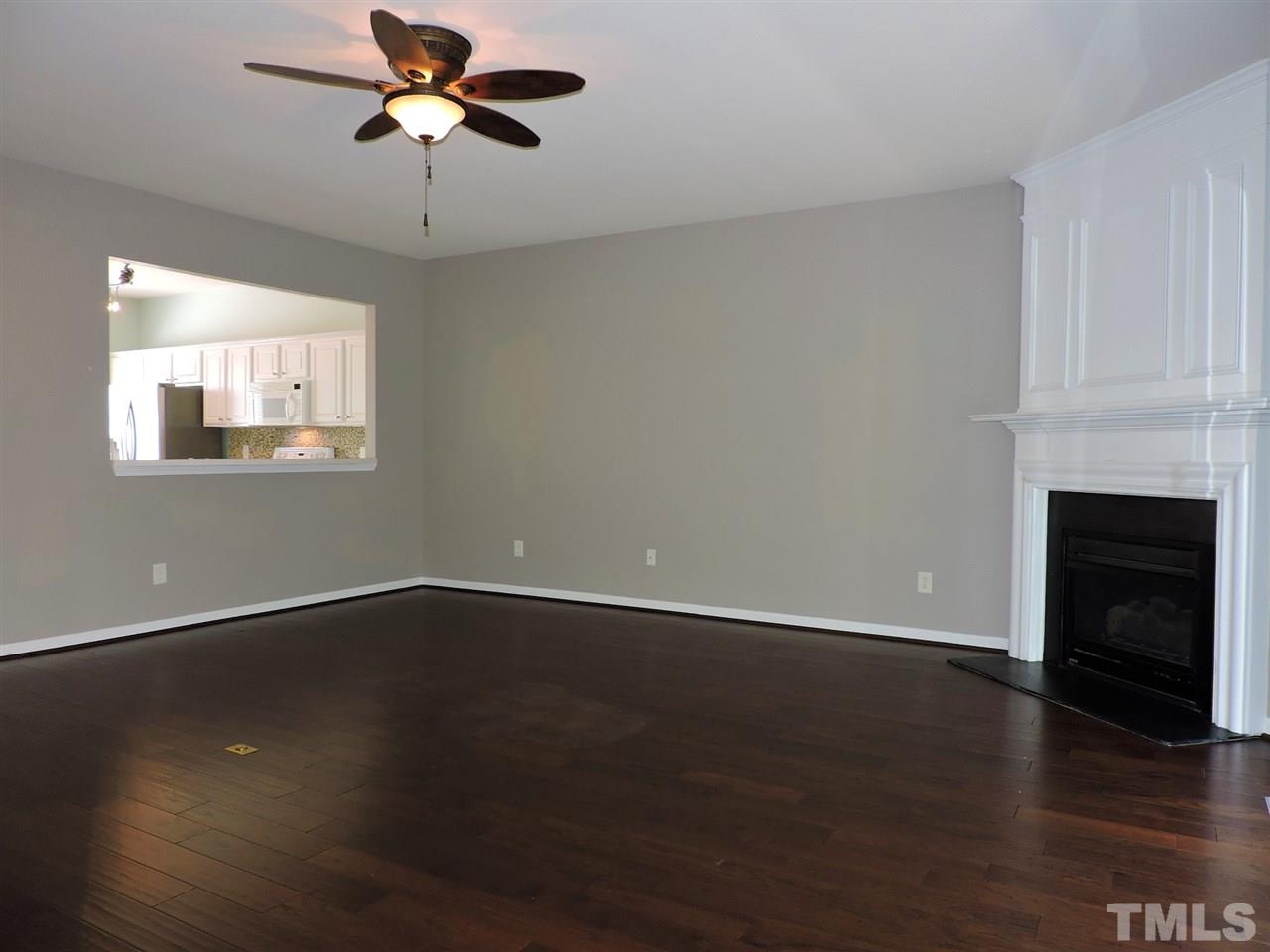 7242 Janston Drive Raleigh, NC 27613 - Photo 8 of 24 a view of an empty room with wooden floor and a window