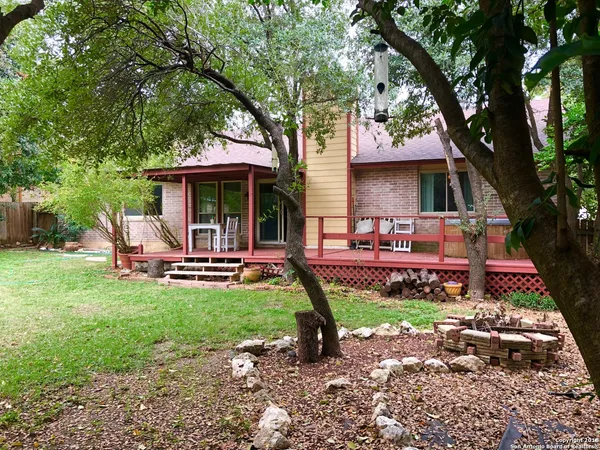 a view of a house with backyard porch and sitting area