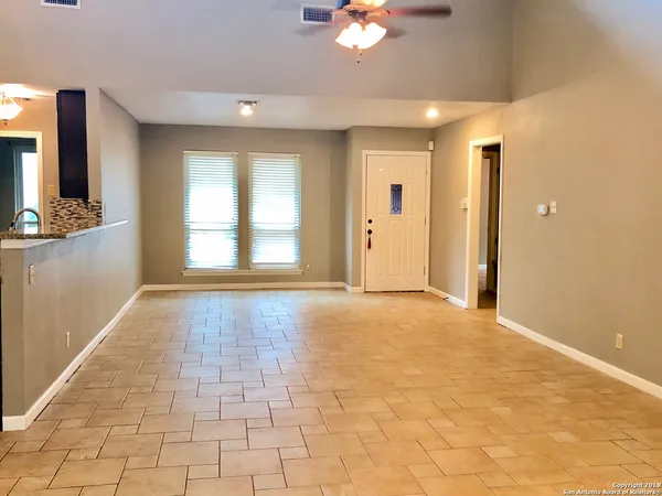 a view of hallway with a window and chandelier